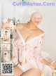 a woman in a pink robe is posing for a magazine