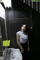 A woman standing next to a sink in a bathroom.